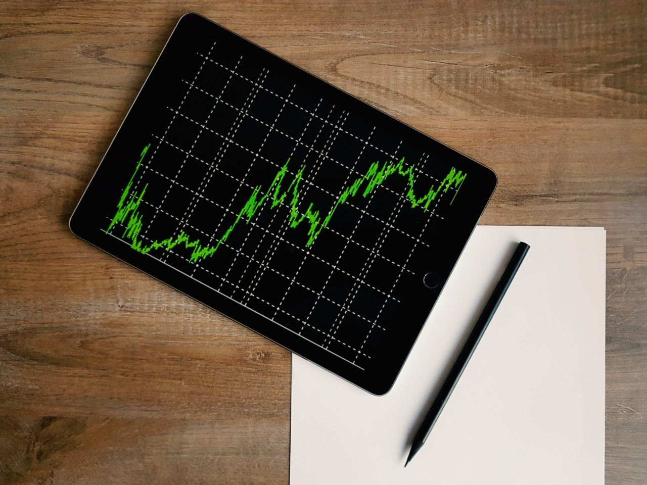 space-grey-ipad-air-with-graph-on-brown-wooden-table - deyco consulting Mecanización contable y fiscalidad